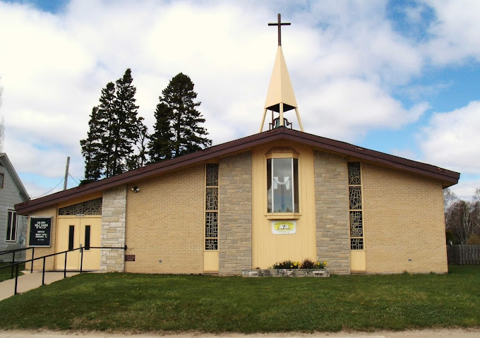 Brick church with steeple and cross