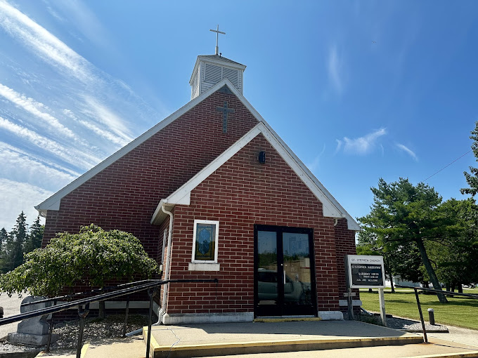 Red brick church building under blue sky