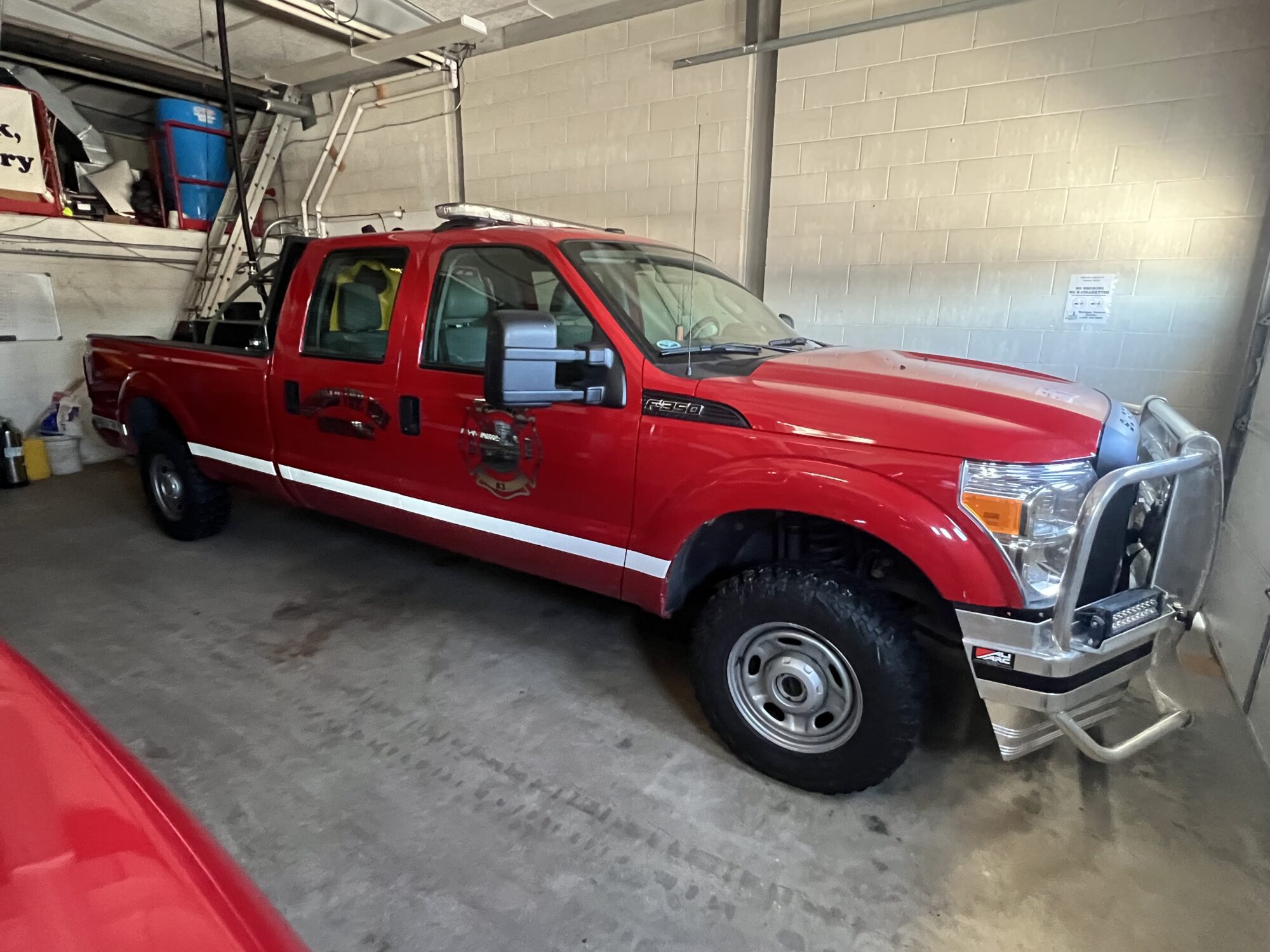 Red fire department truck parked in garage