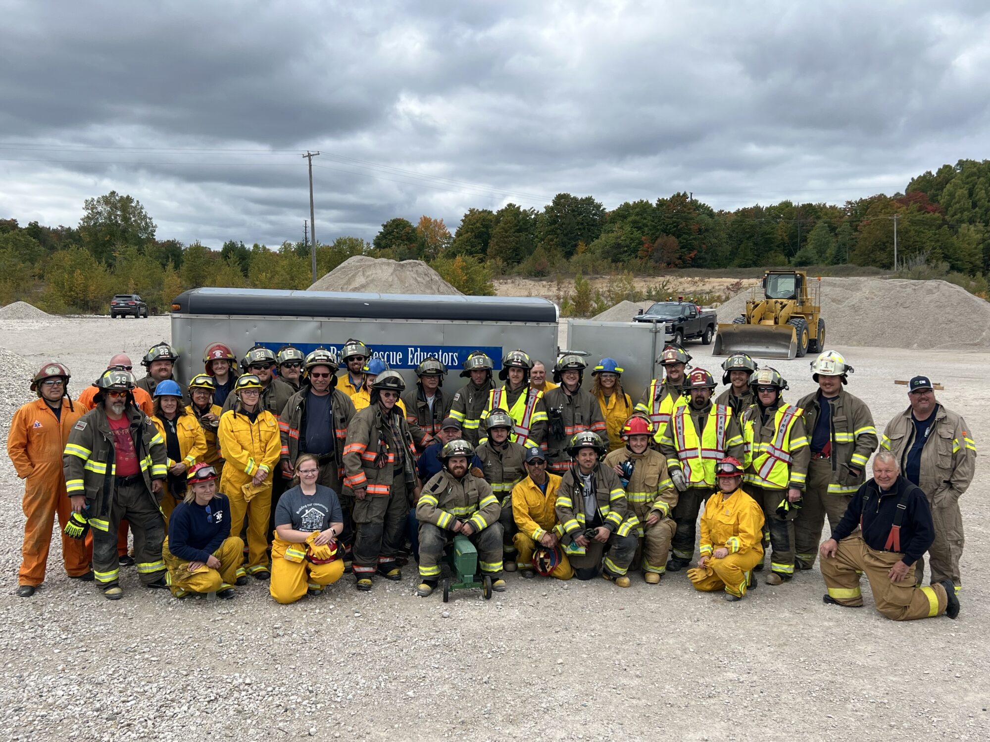 Group photo of firefighters in safety gear outdoors.