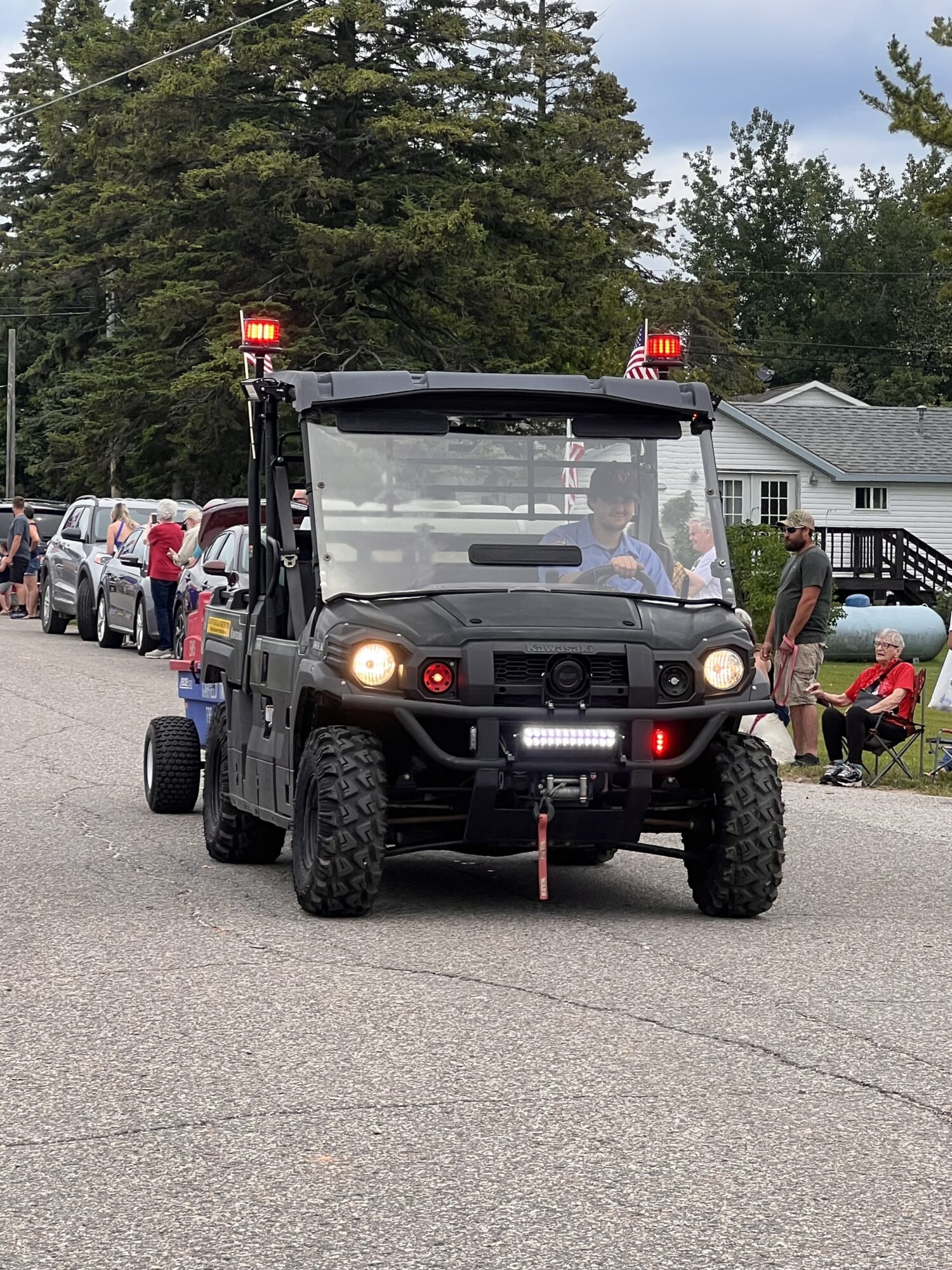 Black utility vehicle in a community parade.